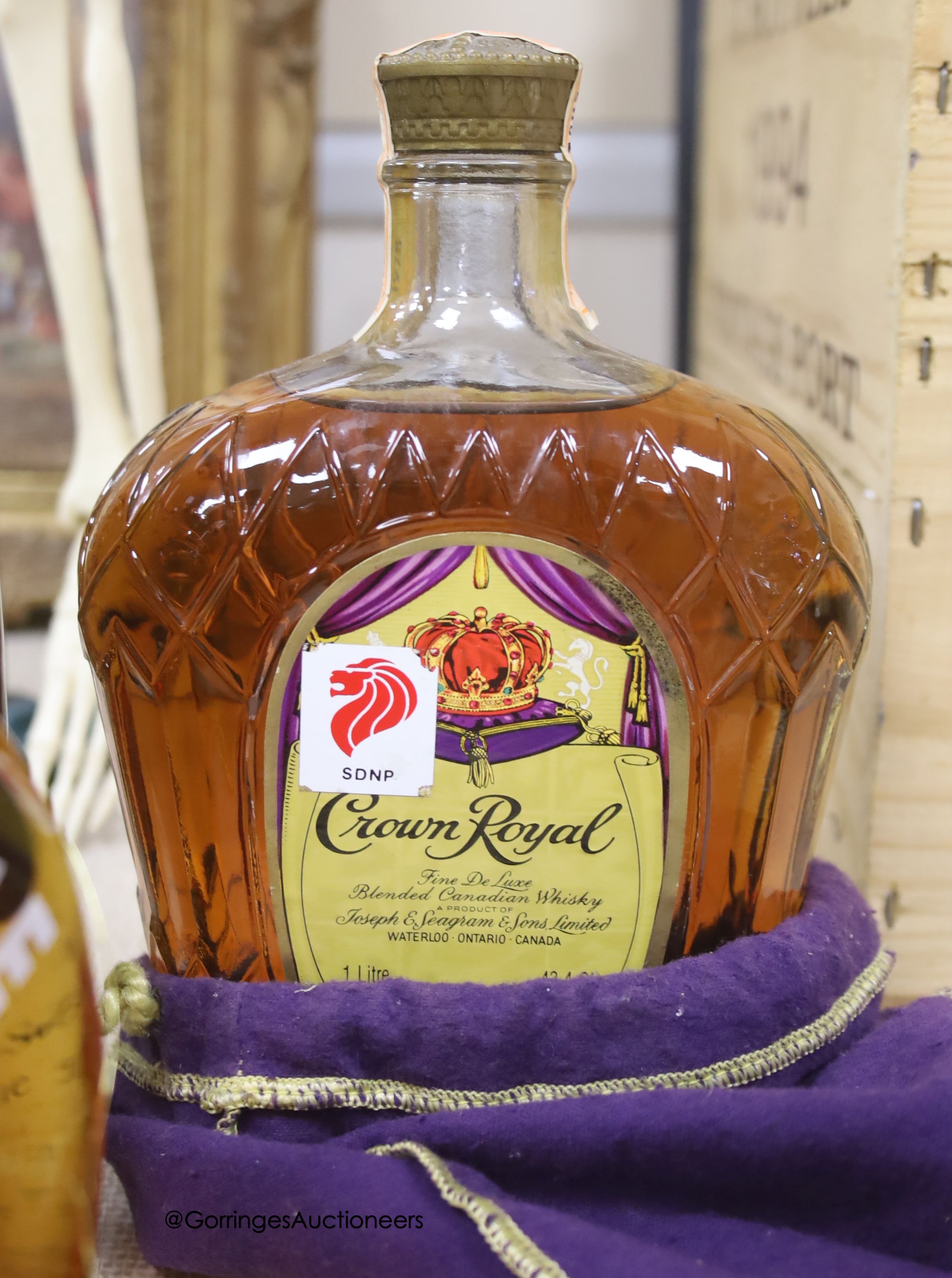 One bottle of Haig Dimple Scotch Whisky, one Crown Royal Canadian Whisky, one Bols Ballerina and one Royal Over-seas (egue vin de pays wine)